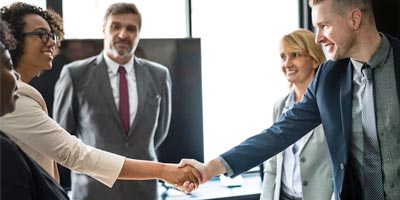 Business professionals shaking hands.