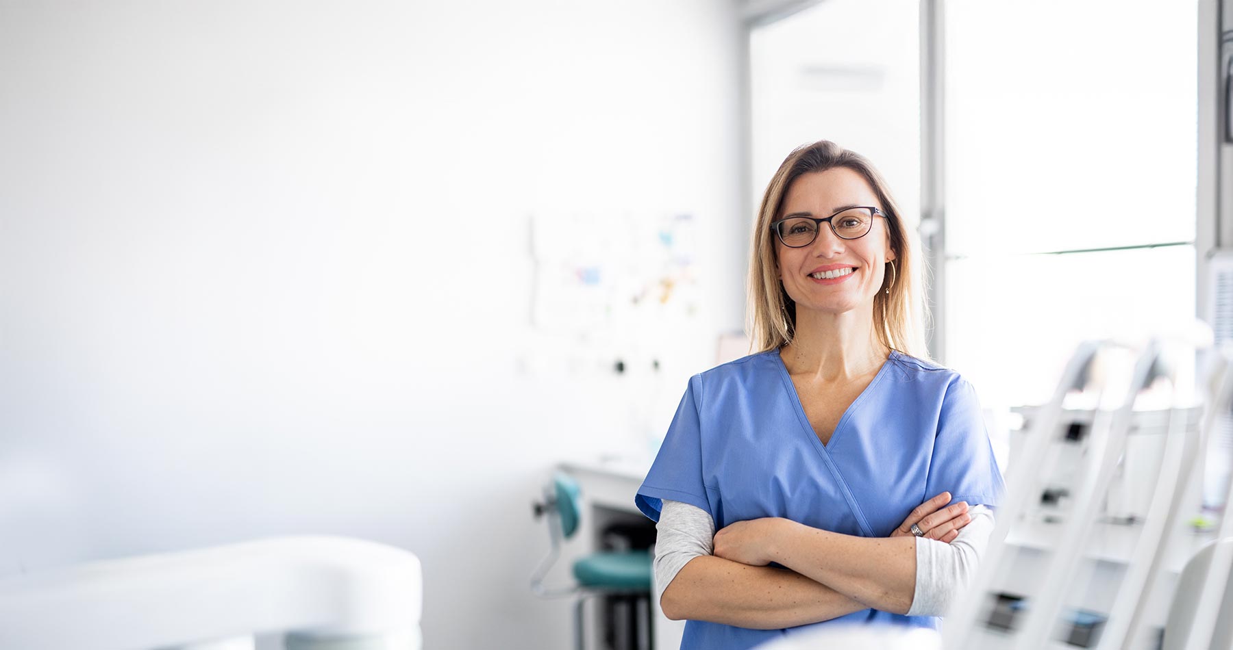 A portrait of dental assistant in modern dental surgery, looking at camera.